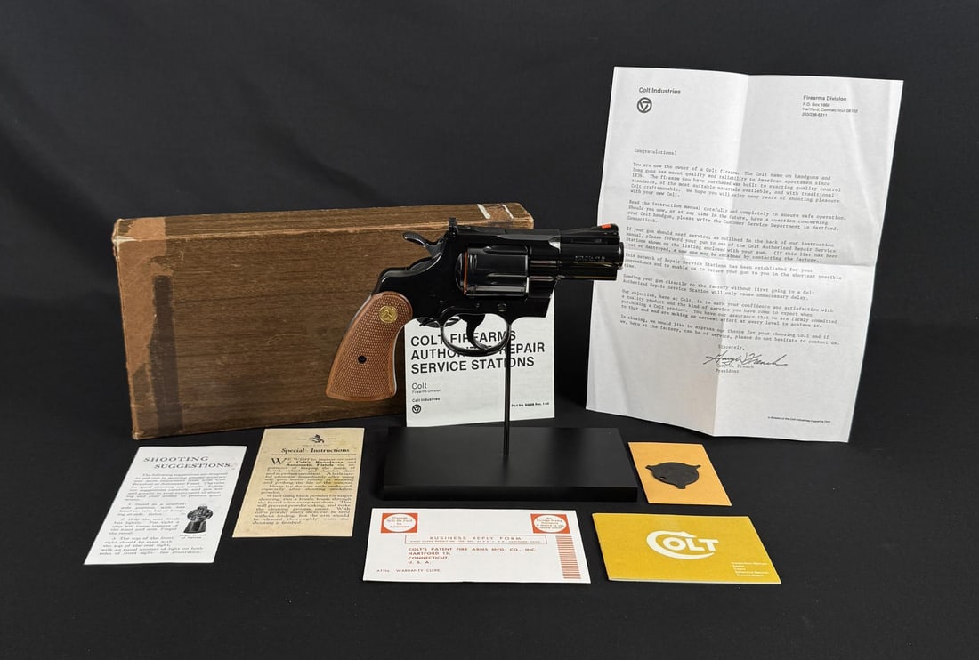 1968 Colt Python 2.5" Barrel .357 Mag Revolver: Exceptional example in original box. 2 1/2" Barrel. Red ramp front sight with white outline square notch adjustable rear sight. 6-shot fluted cylinder. Colt blue finished with polished hammer sides. 2