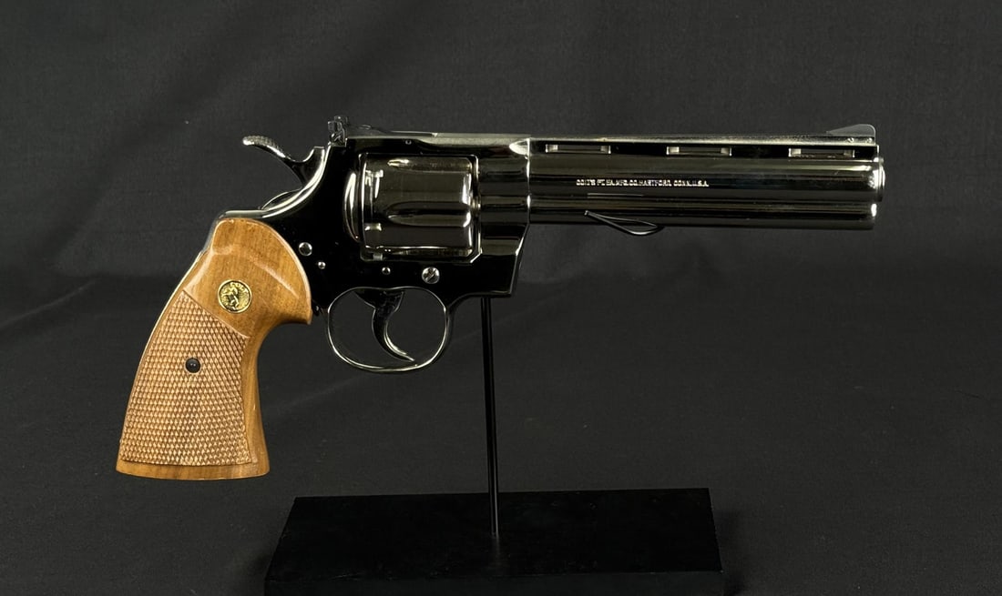 1981 Colt Python Nickel .357 Mag Revolver: 6" vent ribbed barrel with blued, pinned, ramped serrated blade front sight plus full under lug. Frame mounted blued Colt Accro rear sight. Mfg. 1981 (1955-1996) as most recognizable and desired "Snak