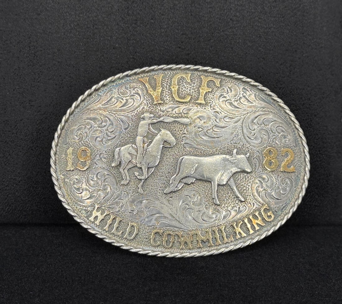 1982 Wild Cow Milking Cowboy Sterling Belt Buckle: 10k Gold and Sterling Silver. Made by Diablo. 108.8 grams. 3" by 4".