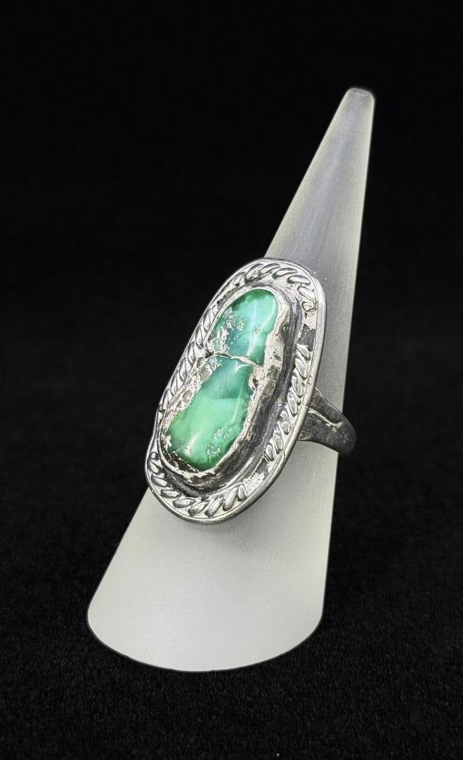 Navajo Sterling Silver Turquoise Ring: Stone is cracked. Size 8 1/2. 10.29 grams.
