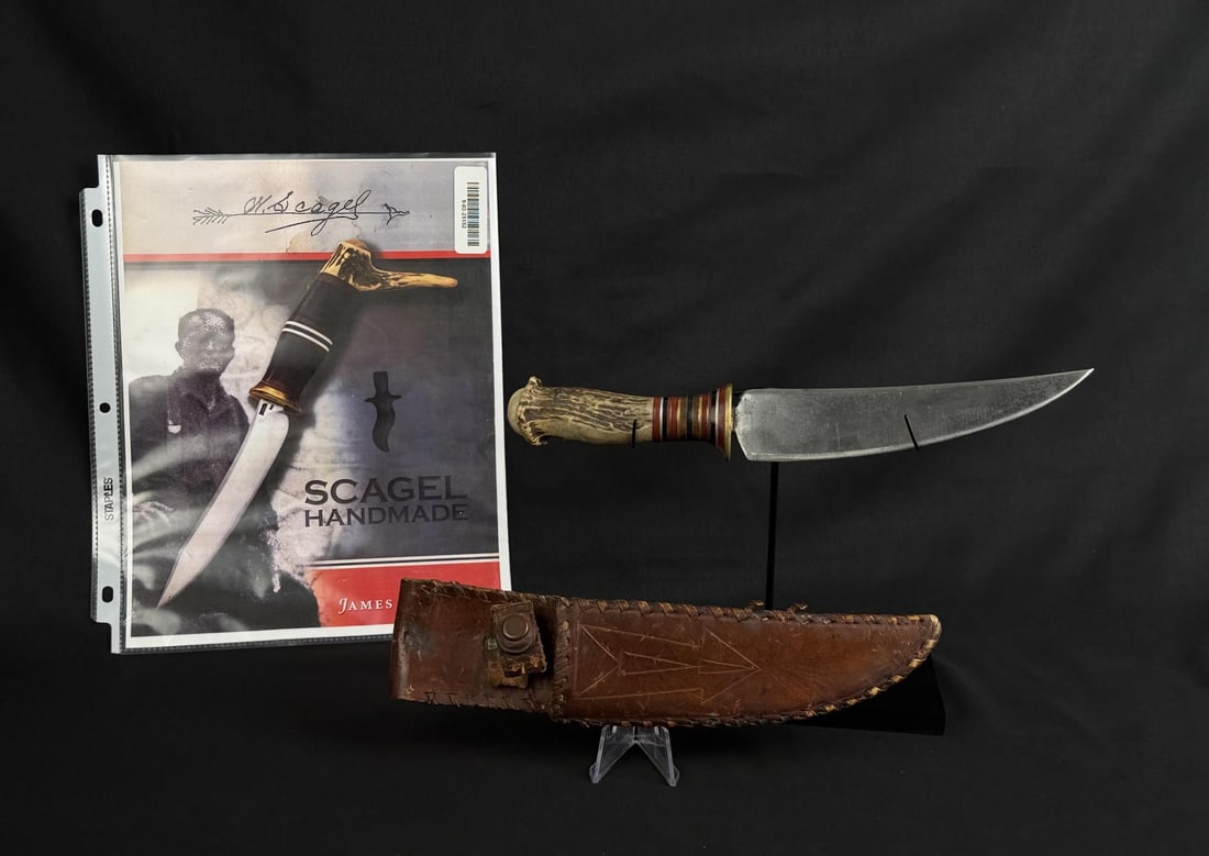 William Scagel Stag Hunter Knife: Unmarked. 11 3/4" long. Leather sheath snap is labeled United Carr. Leather is torn at snap retention area. From the Esteemed Norm Greenberg Collection. In Dr. Lucie in his definitive Scagel text, sta