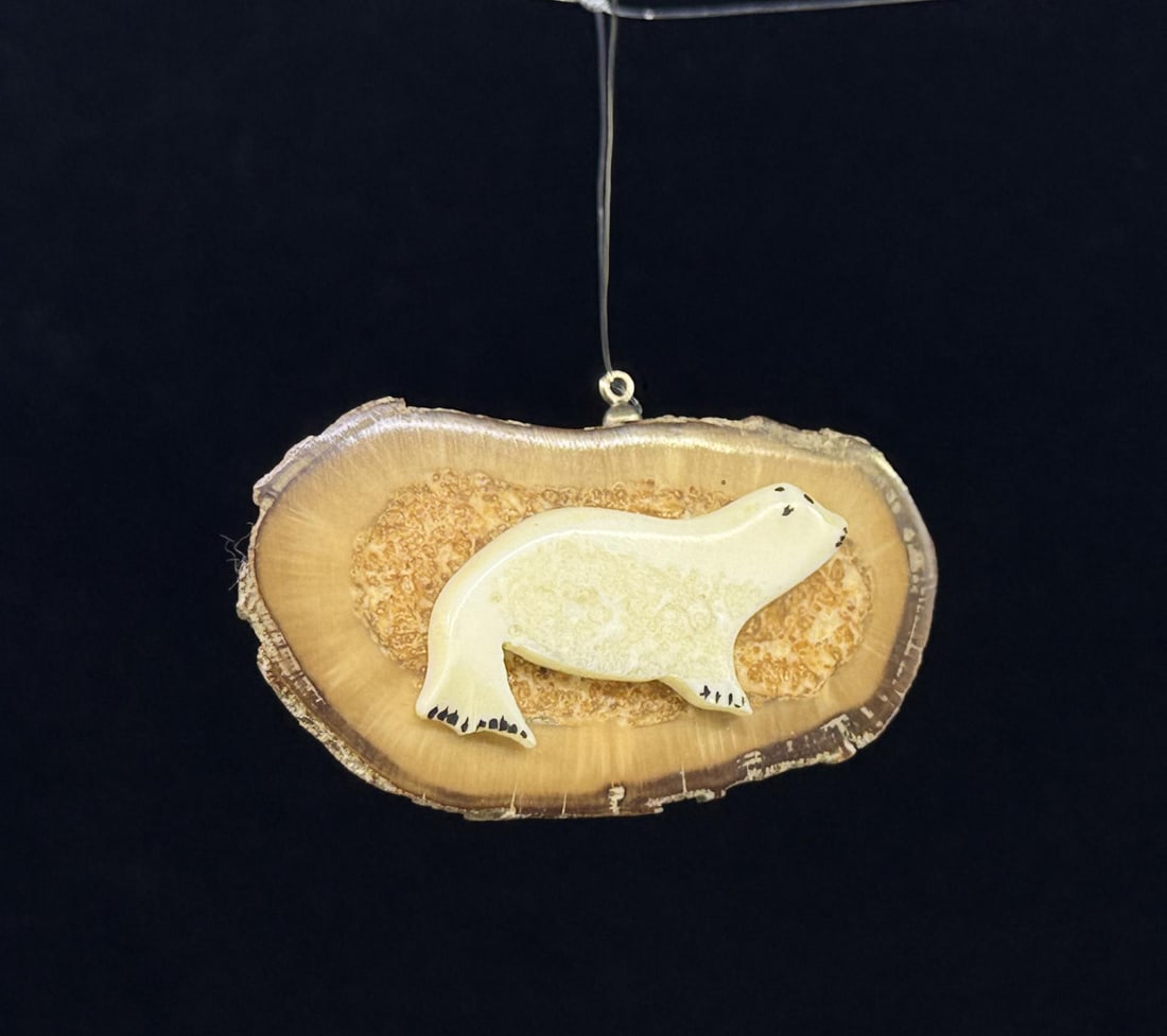 Roger Ozenna Diomede Eskimo Ivory Seal Pendant: 2 1/4" long. Native made prior to 1972. This item cannot be shipped to Oregon, California, Hawaii, New York, New Jersey, Internationally, or any other state that prohibits.