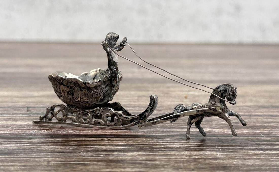 .800 Silver German Miniature Chariot Salt Cellar: 3 1/2" by 1 7/8" by 1 1/4". 31.87 grams. Repousse hallmark reads .800 German silver.