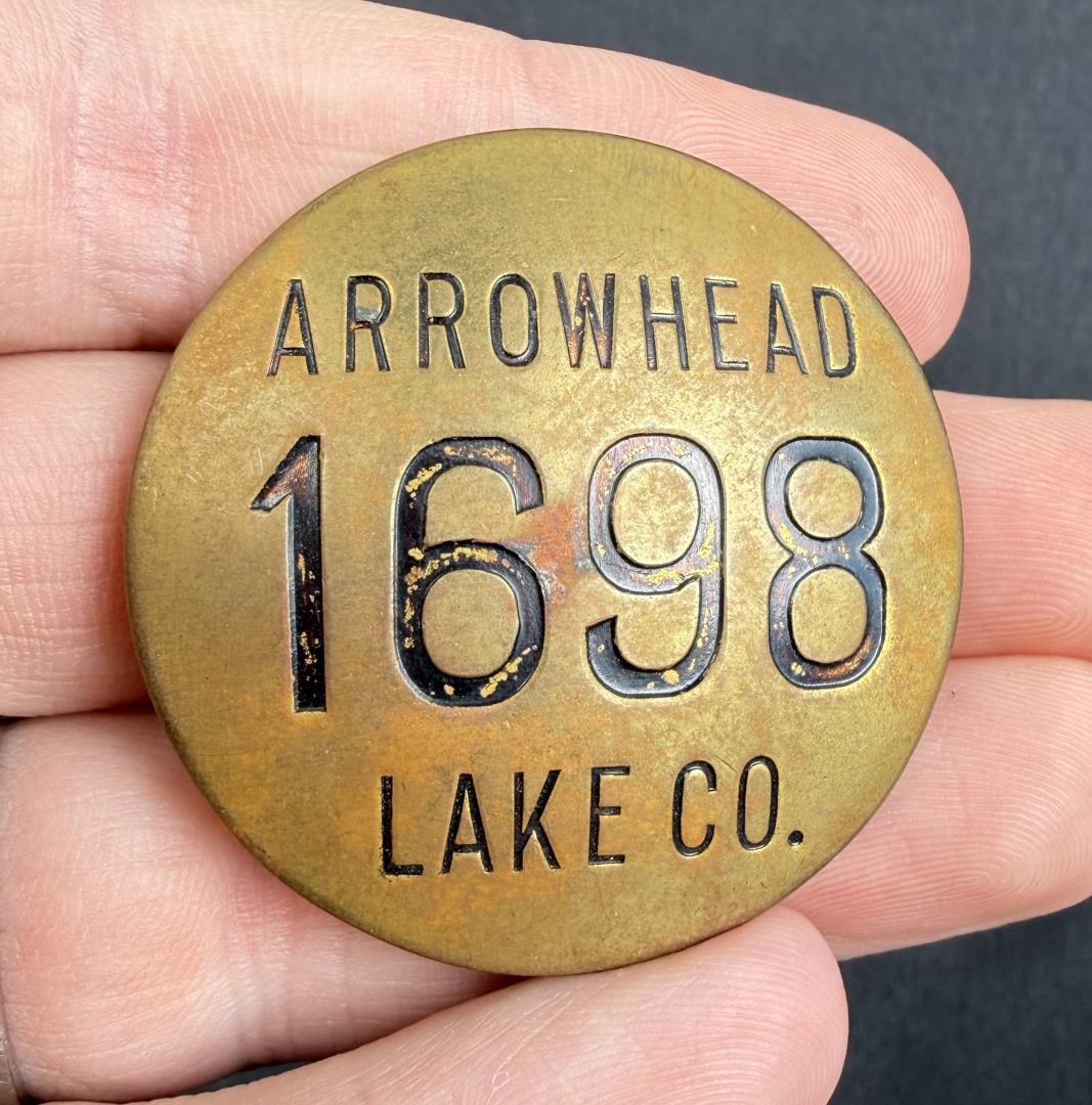 Arrowhead Lake Hotel Company California Badge: 1 5/8" diameter. The history of Lake Arrowhead Village began in 1920 when The Arrowhead Lake Company, a Los Angeles syndicate, bought Little Bear Lake (the original name of the area) and surrounding l