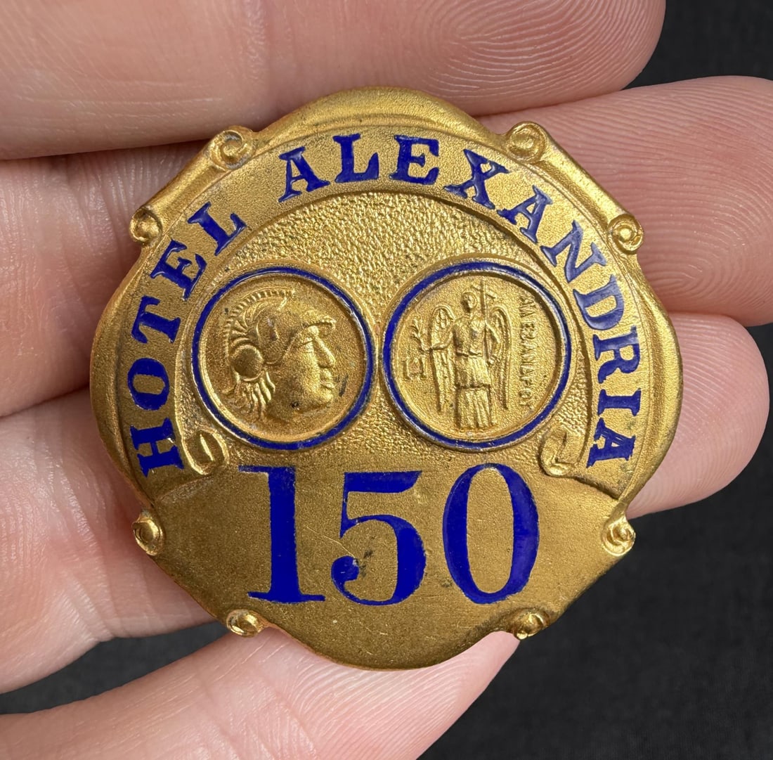 Hotel Alexandria Los Angeles California Badge: 1 1/2" diameter. The Hotel Alexandria is a historic building constructed as a luxury hotel at the beginning of the 20th century in what was then the heart of downtown Los Angeles. Due to its elegant d