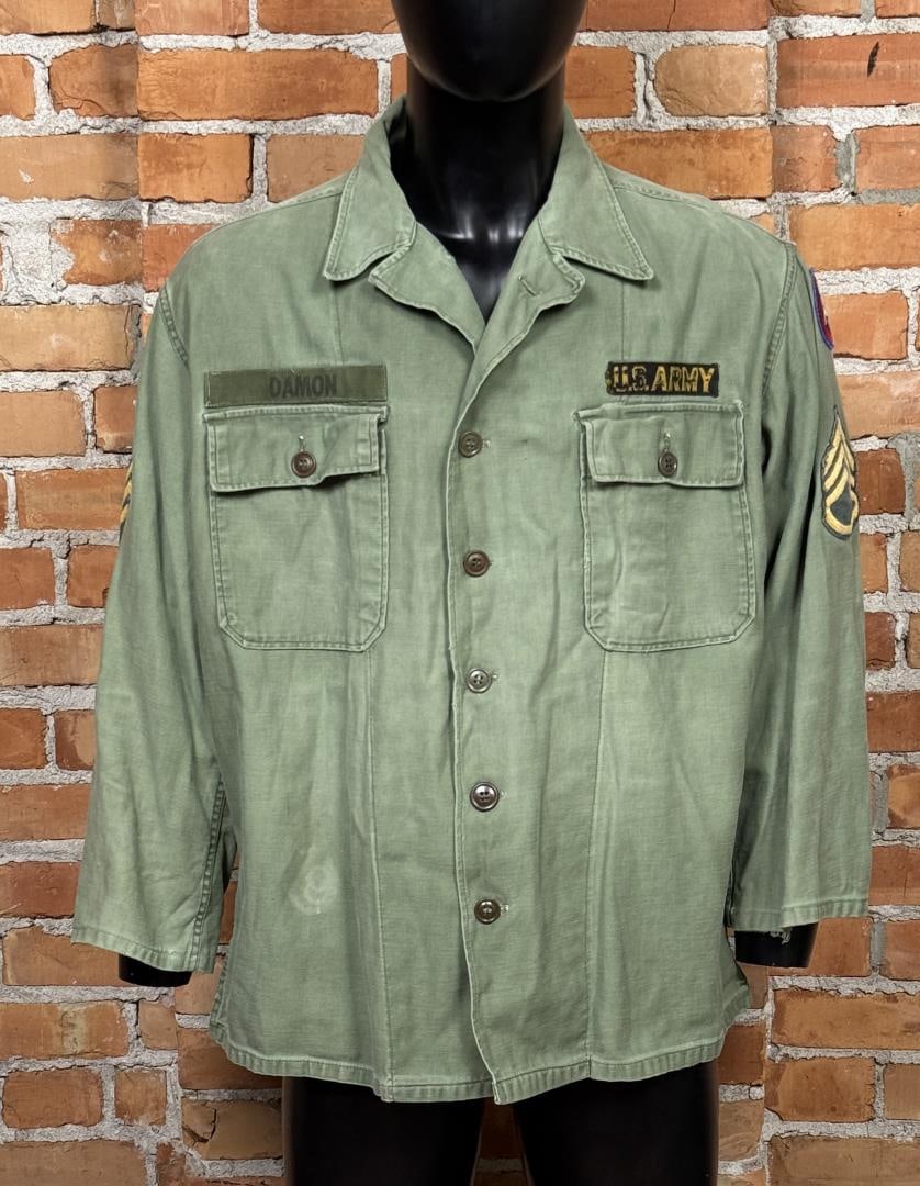 Named US Army Sateen Utility Shirt OG-107: Tags are absent, measures 23" from armpit to armpit and 29 1/2" from top to bottom. Includes 3rd army, and sergeant ranking patches. A small, black patch has been applied as well.