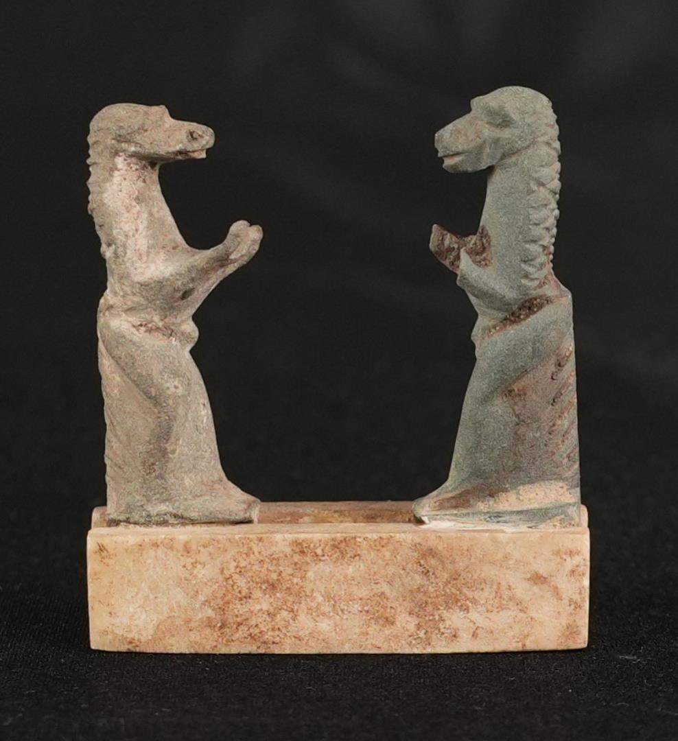 Ancient Egyptian Baboon Sun Worship Statuette: 2" by 1 3/4" by 1/2" on stand. Late Period to Ptolemaic period, 664-30 B.C. Provenance: From the estate of Andrew Cunningham Ware. Previously, Larissa Bjuggren (1916-2004) Acquired by her in Egypt and