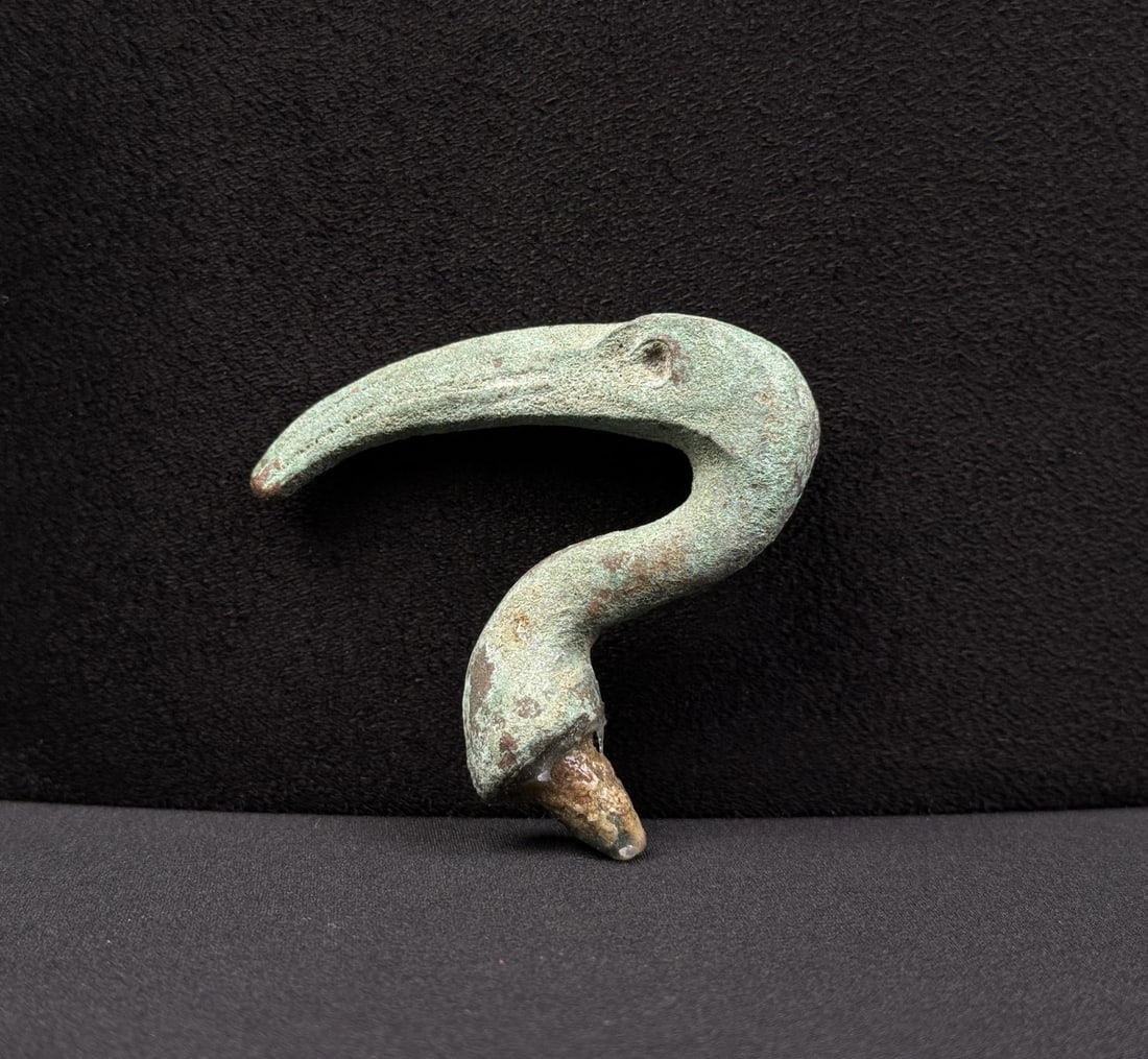 Ancient Egyptian Bronze Ibis Head: 2 3/8" by 2 1/4" by 5/8". Late Period, 26th-30th Dynasty, 664-332 B.C. Provenance: From the Iris Cornelia Love Collection (1933-2020), New York, primarily formed in the 1950s-1970s. Exhibited: North C