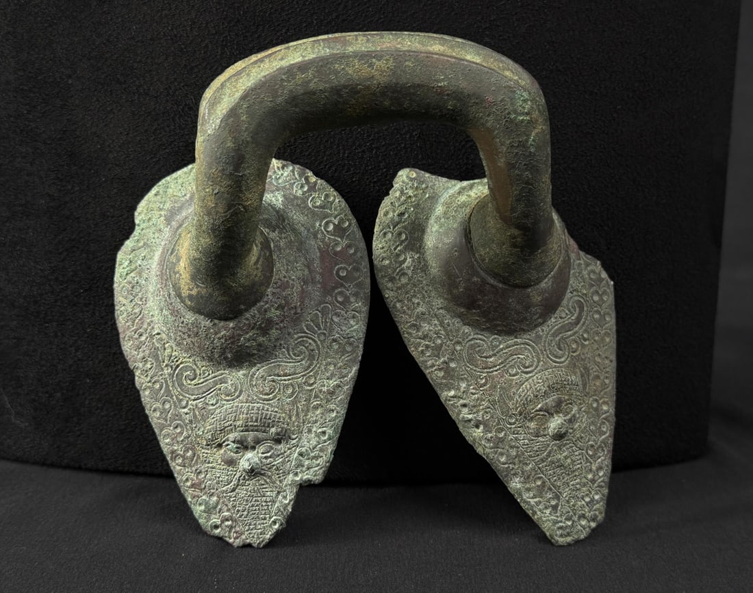 Ancient Etruscan Bronze Stamnos Handle: 5 1/2" by 4 1/4" by 3 1/2". Circa 5th Century B.C. Provenance: From the Iris Cornelia Love Collection (1933-2020), New York, primarily formed in the 1950s-1970s. Iris Cornelia Love (1933?2020) was an