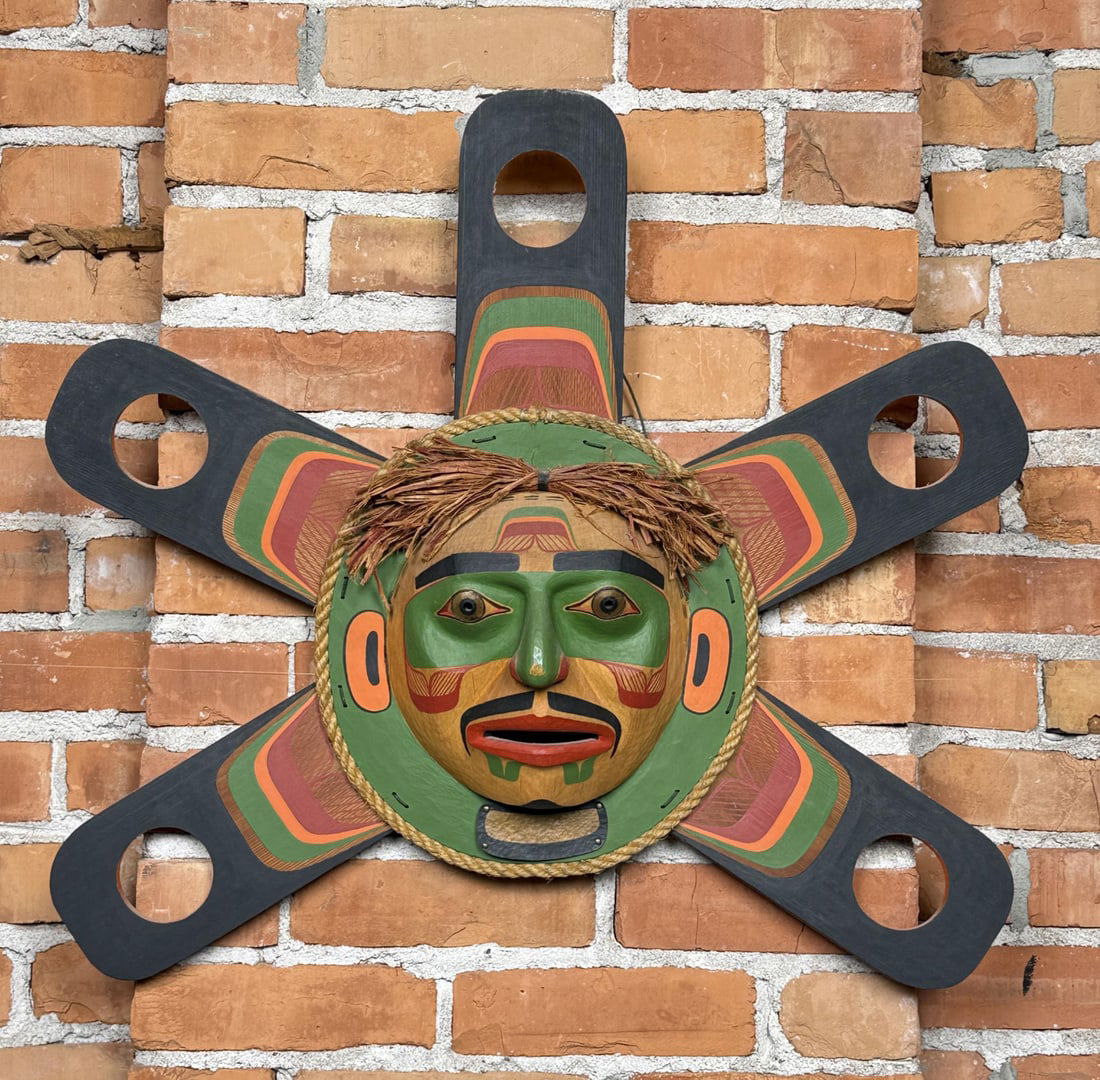 Joe Peters Kwakiutl Northwest Coast Sun Mask: 27" by 23" Joe Peters Jr. (1959/1960?1994) was a Kwakwaka?wakw artist from Alert Bay, British Columbia, working within the Northwest Coast carving tradition. He was born into a family with strong cere