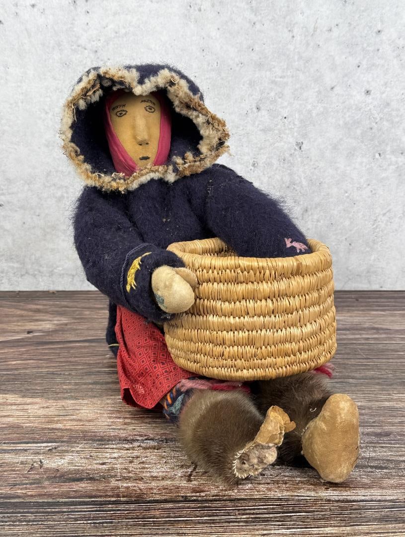 Alaskan Inuit Eskimo Woman and Basket Doll: One foot damaged, missing moccasin. 6 1/4" by 8 5/8" by 10". Mid 20th century.