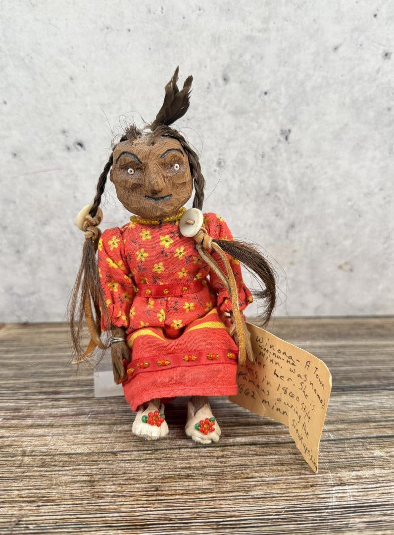 Sioux Native American Indian Doll: This hand carved wooden doll is from the Mdewakanton, a band of Sioux tribe in Minnesota. 5 3/4" tall by 5 1/2" wide. Late 20th Century. Features a nice chevron trade bead on her necklace.