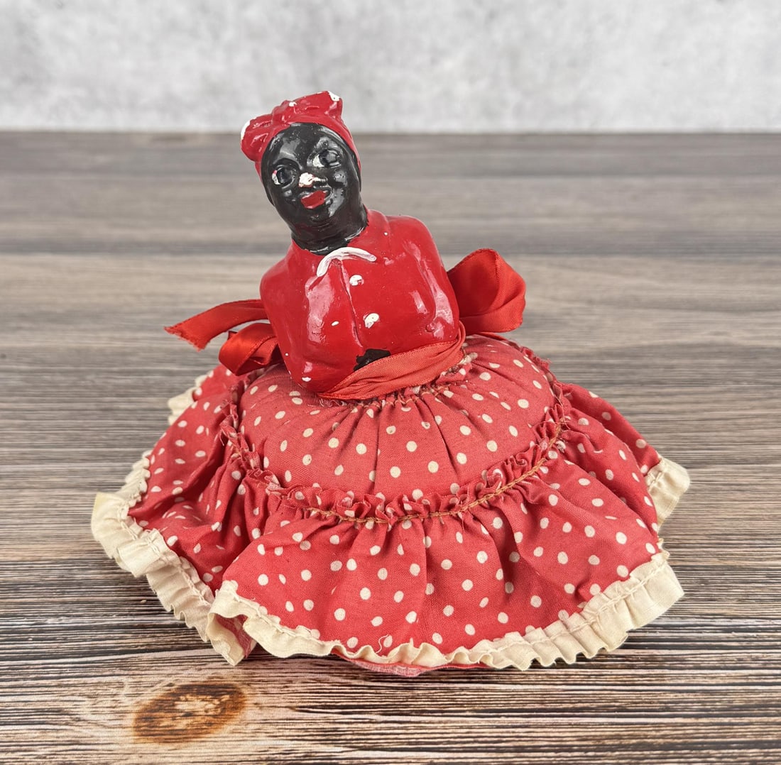 Chalkware Black Americana Mammy Pin Cushion: Some light damage on her face and head as shown. 6 1/2" diameter by 5" tall.
