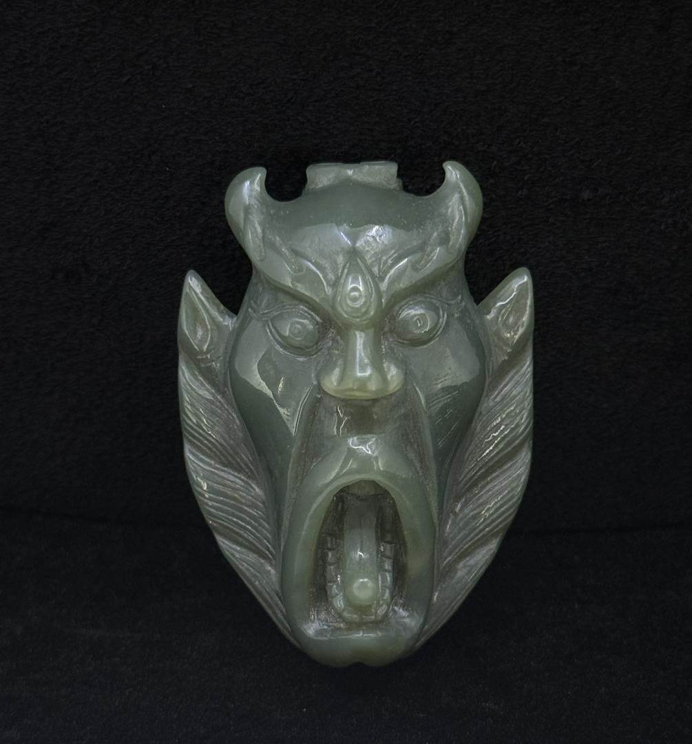 Carved Jade Guardian Mask Belt Buckle: 68.03 grams. 1 5/8" by 2 3/8".