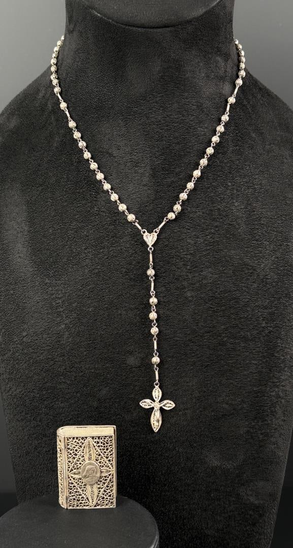 .800 Silver Rosary and Mini Bible Case: .800 silver. 29.32 grams. Necklace is 14" long. Book case is 1 7/8" by 1 1/4".