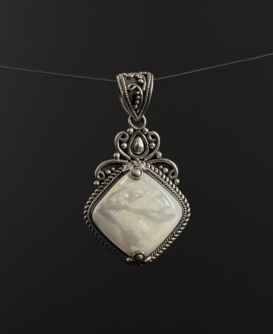 Sterling Silver Mother of Pearl Pendant: 17.9 grams. 2" long.