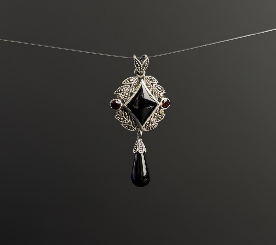 Sterling Silver Garnet Marcasite Pendant: 7.6 grams.