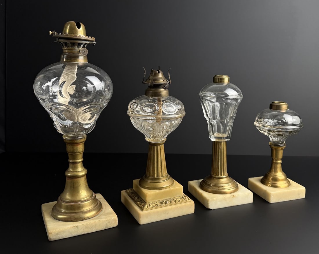 Flint Glass Marble Kerosene Whale Oil Lamps: Largest is 14 1/2" tall. Left has a star and swirl pattern on a brass column and marble plinth with an early brass burner. Second left has a ring and bullseye pattern font on a brass column and