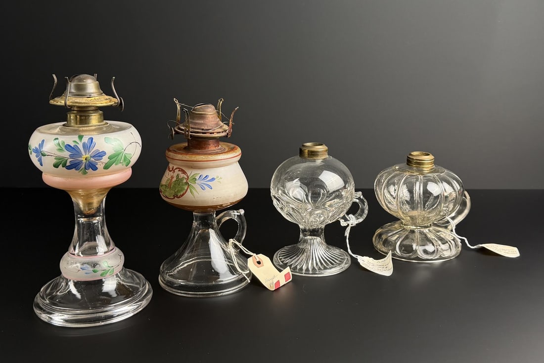 Kerosene Painted Finger Lamps: Largest is 9 1/2" tall. Left has a hand painted floral decoration with an enamel decorated font. Second has an older burner with oxidation and a clear pressed base and applied handle. Third shows a 2