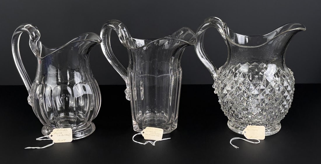 Flint Glass Sawtooth and Paneled Pitchers: Largest is 6 1/8" by 7 3/8" by 8 7/8".