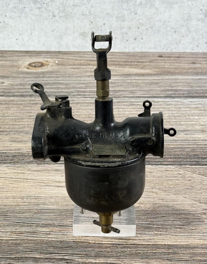 Ford Model T Holley NH Carburetor: Shows the straight through style. 1920-1927. Features a main jet well that supplies fuel to the inlet via two drilled passages.