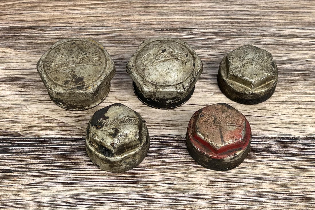 Group of Overland Grease Cap Hubcaps: 5 total.