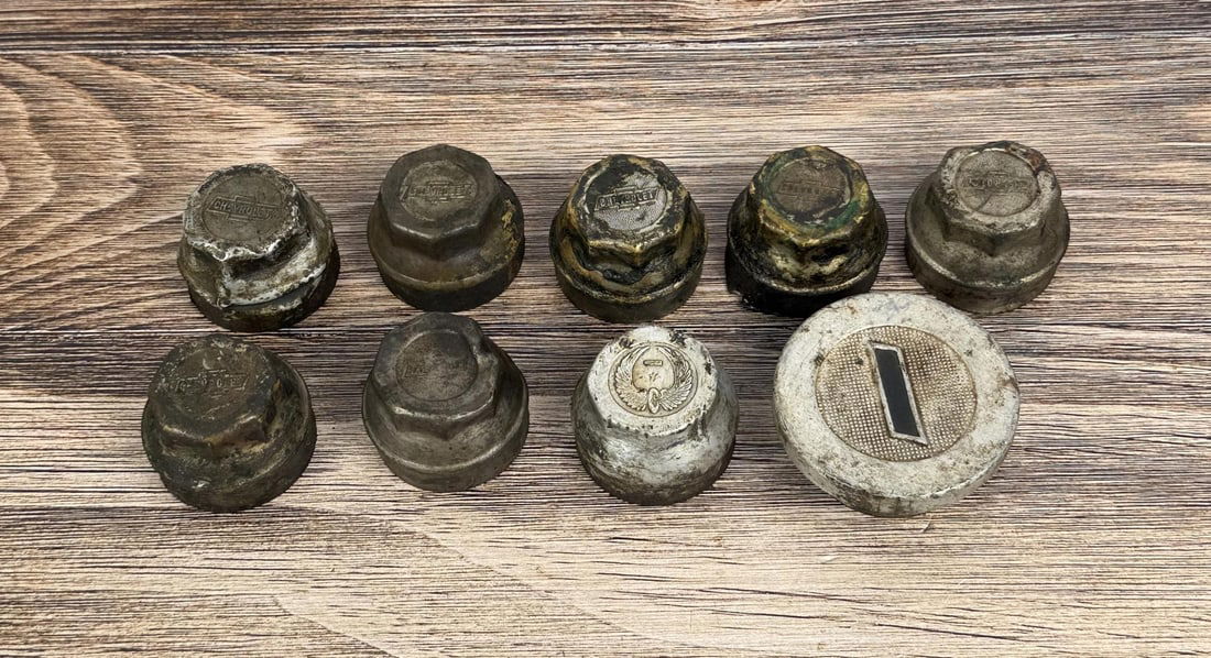 Group of Chevrolet Grease Cap Hubcaps: Group of 9, including Winged Wheel emblem.