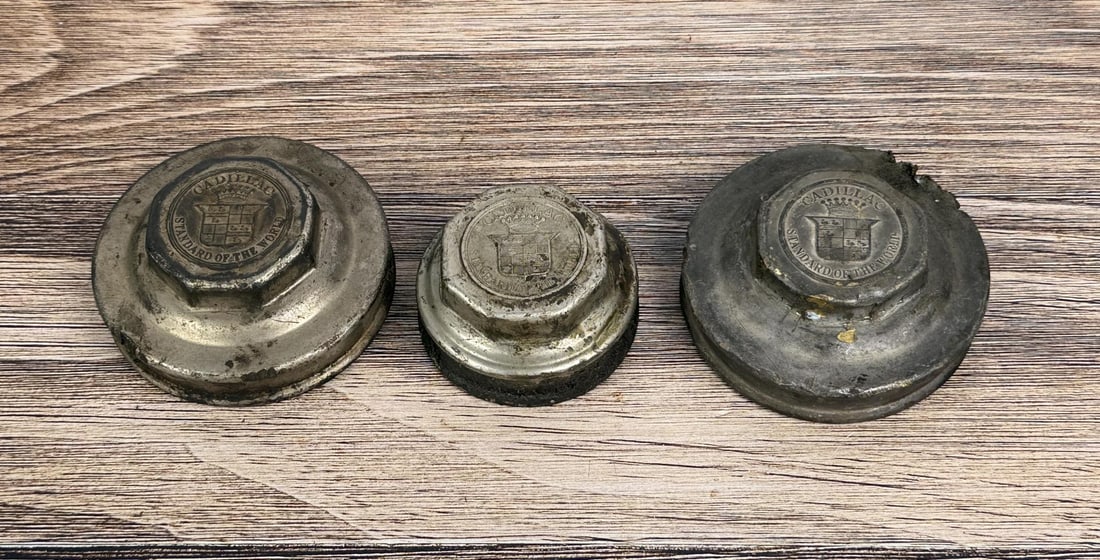 Cadillac Standard of the World Grease Cap Hubcaps: Group of 3.