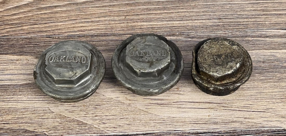 Oakland Automobile Grease Caps Hubcaps: Group of 3.