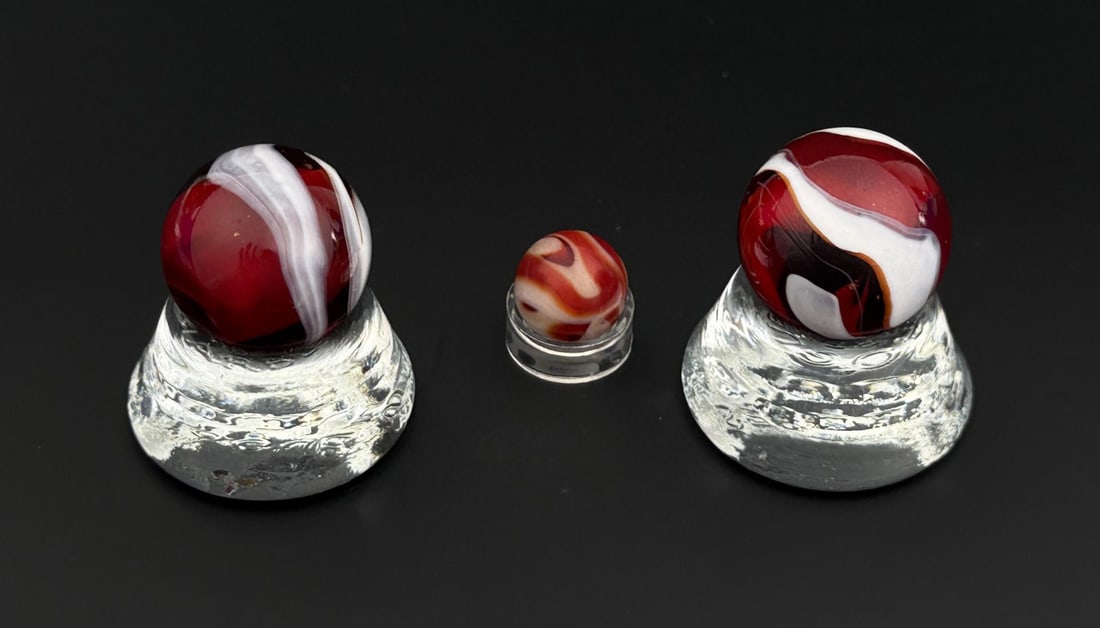 Antique Oxblood Swirl Marbles: Nice grouping. Larger Marbles are 1" in diameter, and smaller marble is 1/2" in diameter.