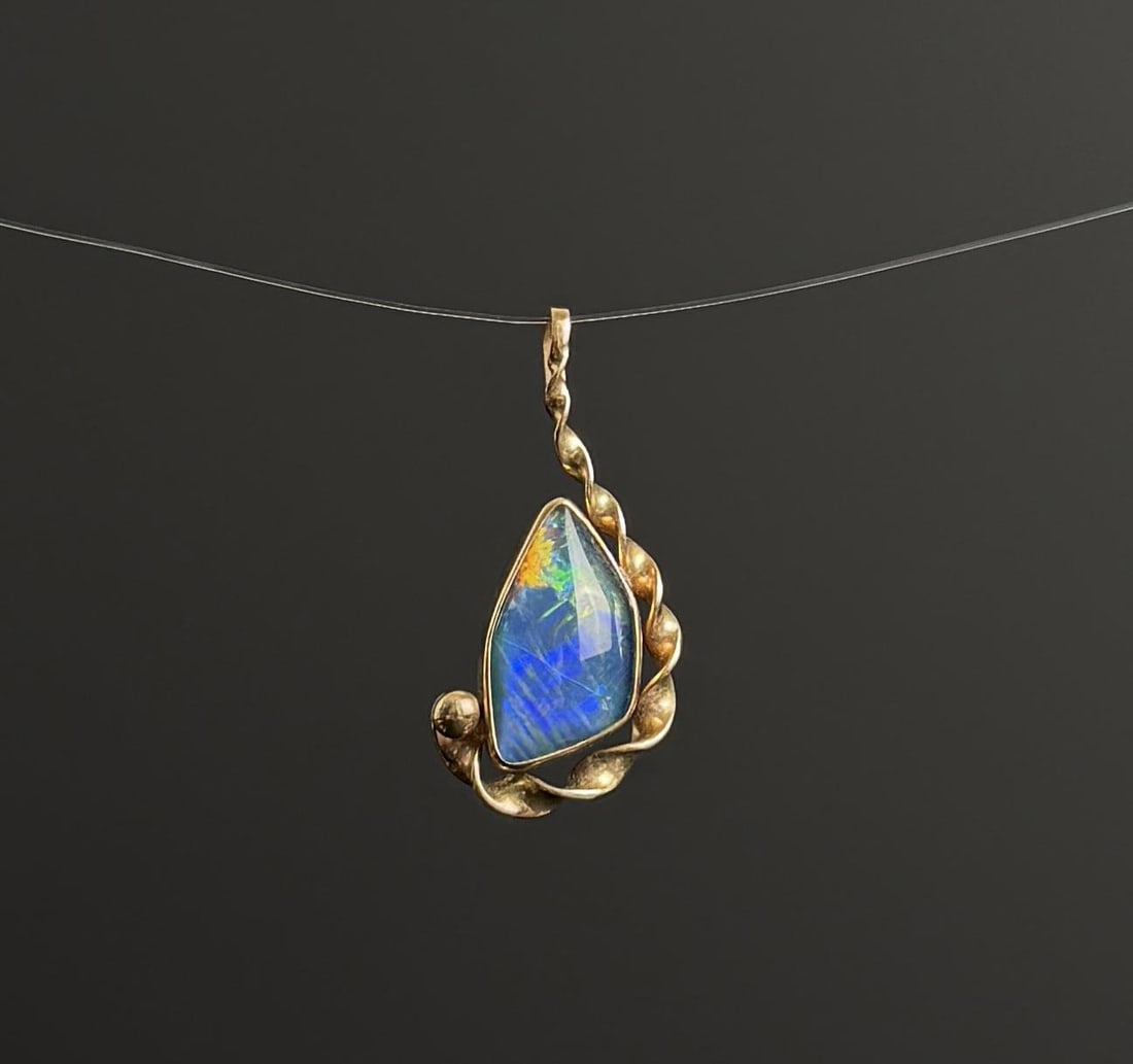 9k Gold Australian Opal Pendant: 2.2 grams. 1 1/8" long.