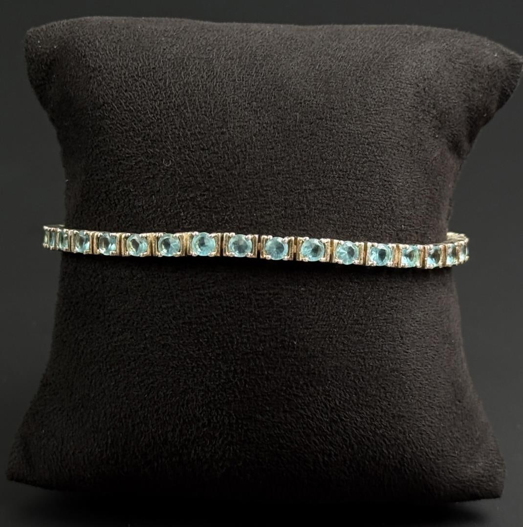 Sterling Silver Blue Topaz Tennis Bracelet: 12.47 grams. 7 1/2" long open.