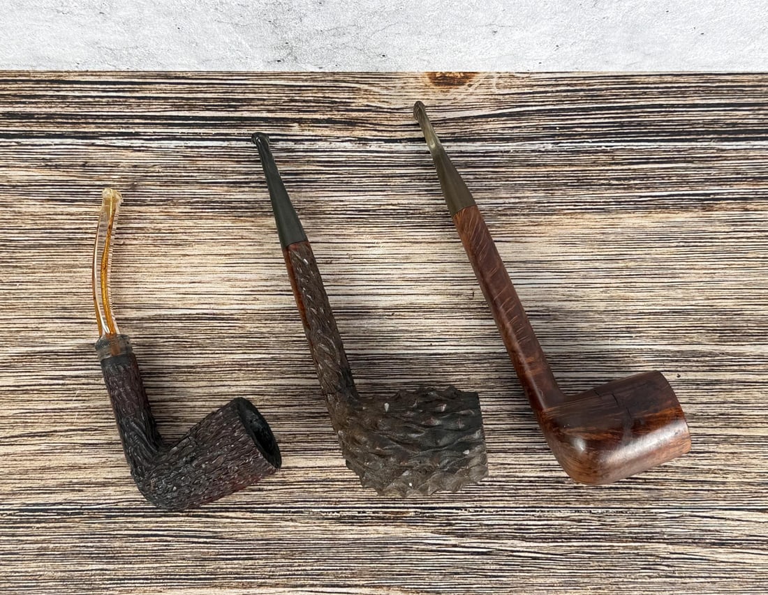 Estate Collection of Tobacco Pipes: Loyds, Churchill's Rough, and one marked D2. Largest is 6 1/2" long.