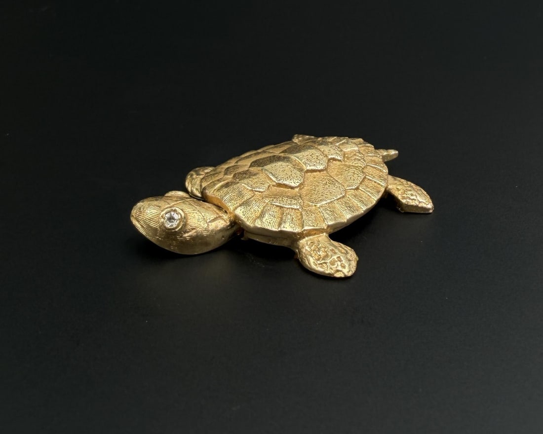 14k Gold and Diamond Turtle: Head moves side to side. 1 1/4" by 1 1/4" by 1/8". 10.87 grams. Lot requires payment via non credit card only.