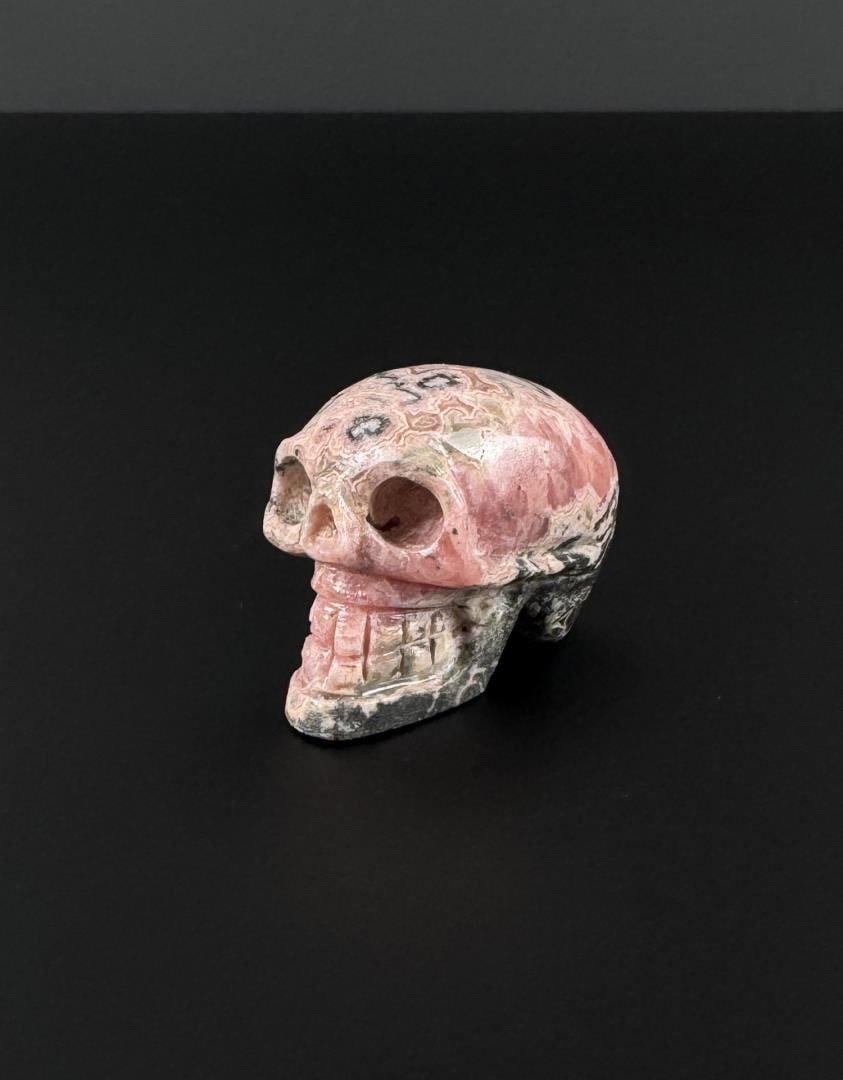 Rhodochrosite Skull Carving: 2" by 1 1/4" by 1 1/4". 94.95 grams.