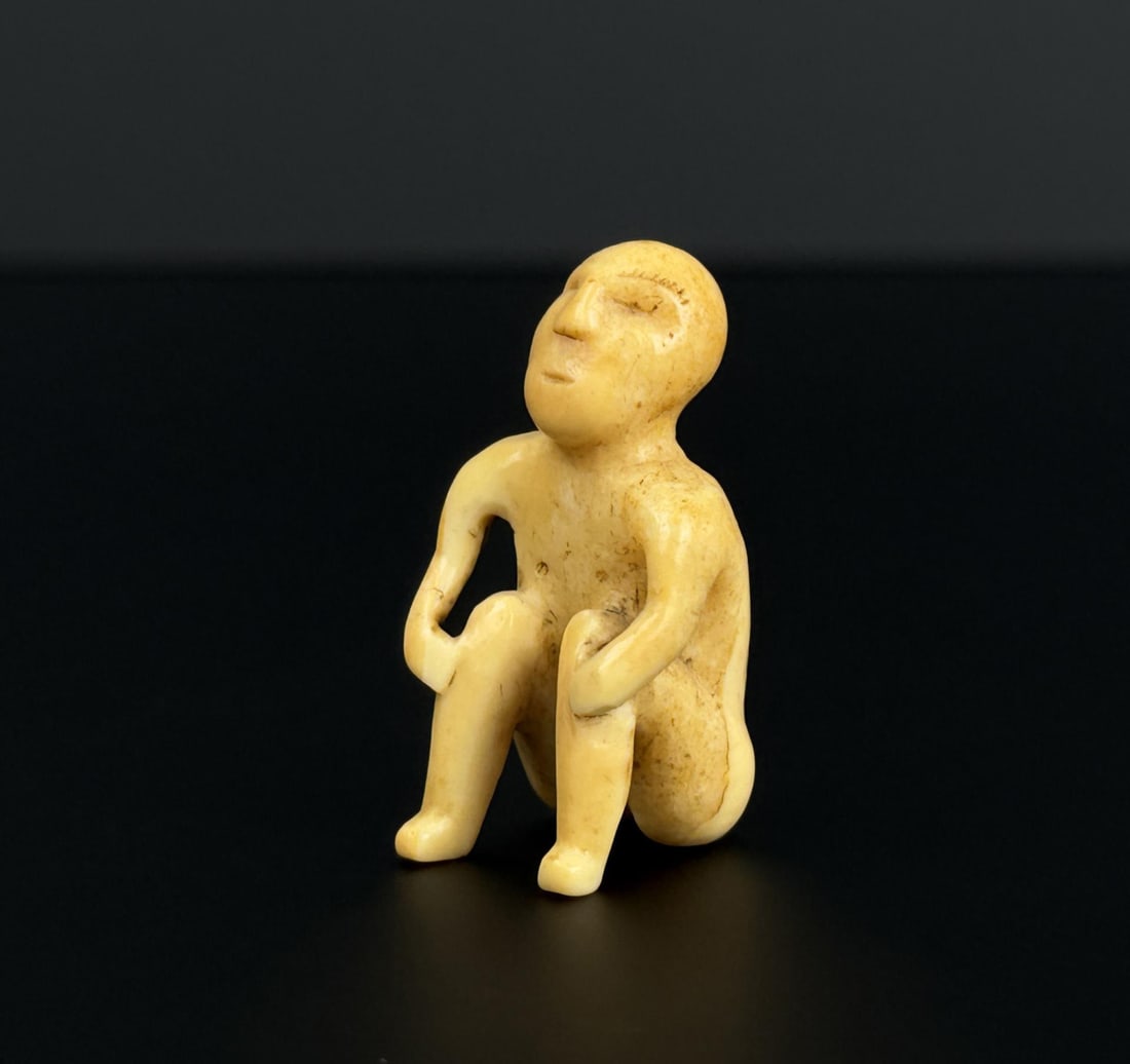 Yupik Inuit Eskimo Chukchi Seated Ivory Figure: 1 5/8" by 1" by 7/8". EASTERN SIBERIA, C. 1500 - 1800 A.D. Native made prior to 1972. This item cannot be shipped to Oregon, California, Hawaii, New York, New Jersey, Internationally, or any other sta
