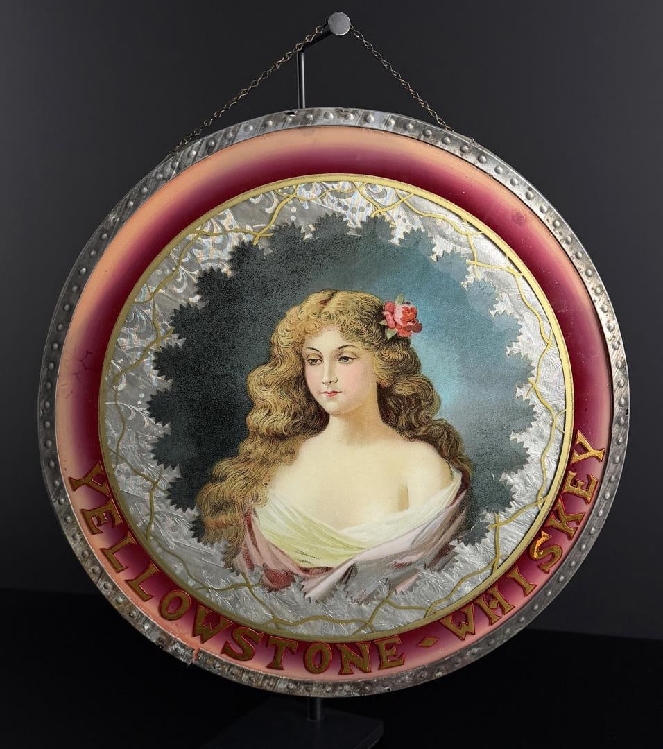 Yellowstone Whiskey Reverse Painted Glass Sign: 14 1/4" diameter. Probably hung in a Saloon. A wonderful and rare reverse painted sign.