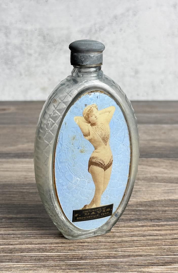 Tennessee Label Under Glass Risque Flask: J. Davis Brownsville Tennessee. 6 1/4" by 3 1/2" by 1 1/4".