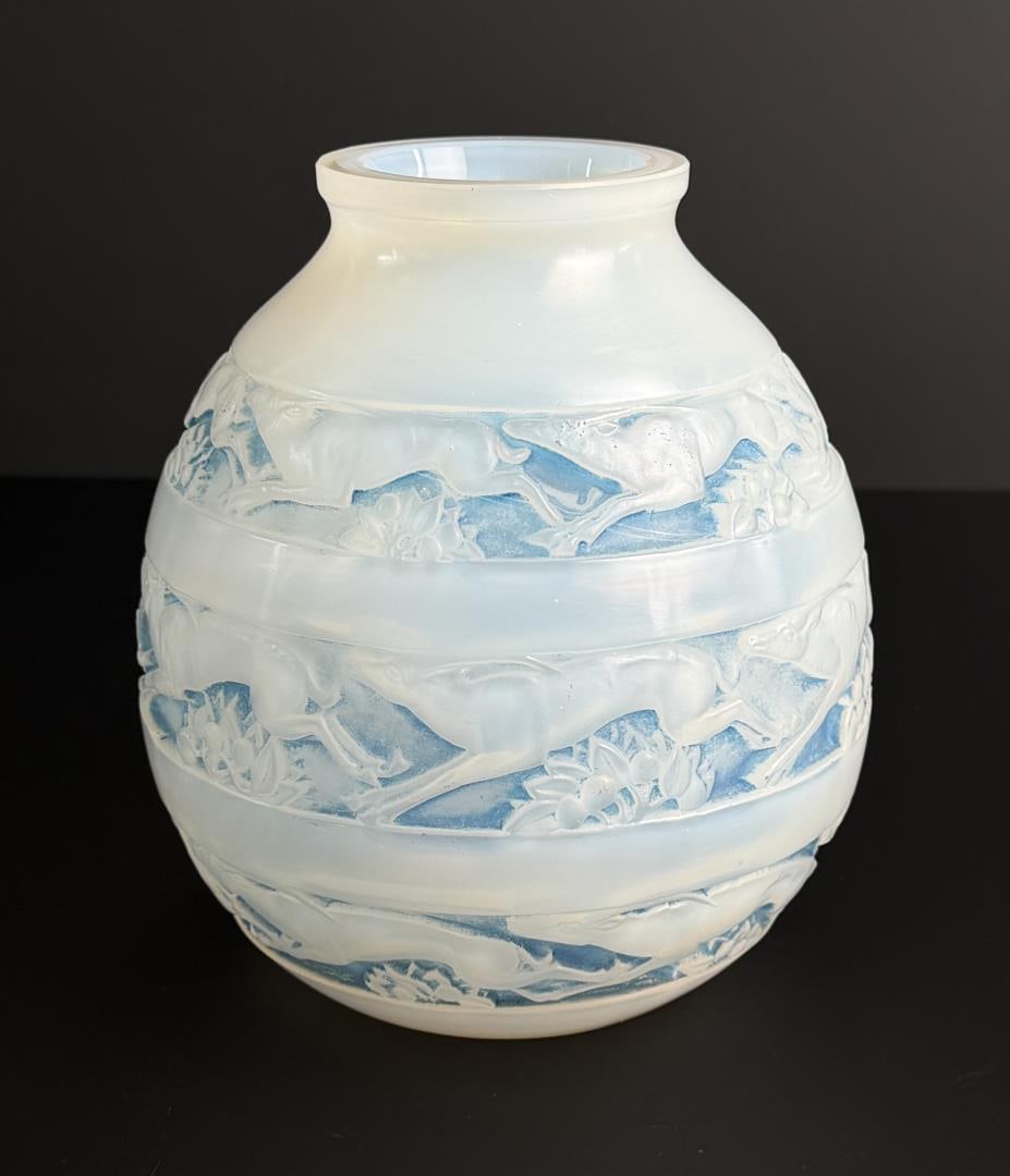 Rene Lalique Blue Stained Soudan Vase: 6 7/8" by 6 1/4" by 6 1/4". Opalescent with a blue stained background pattern of running oryx and bunches of leaves and fruit in continuous bands. Signed. 1928.