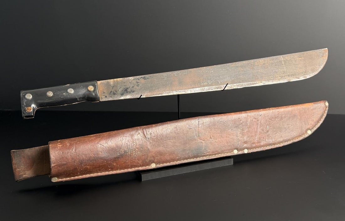 Machete with Leather Scabbard: 23" long.