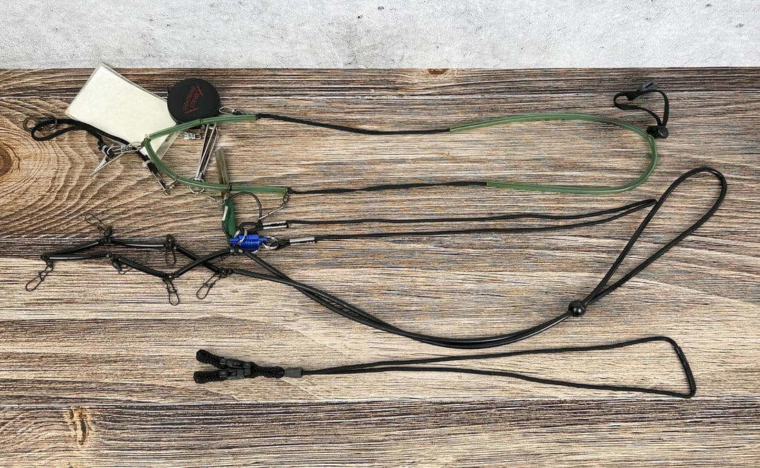 Group of Fly Fishing Lanyards and Tools: Includes nail clippers and a fire starter and a verage weight of bonefish versus fork length chart.
