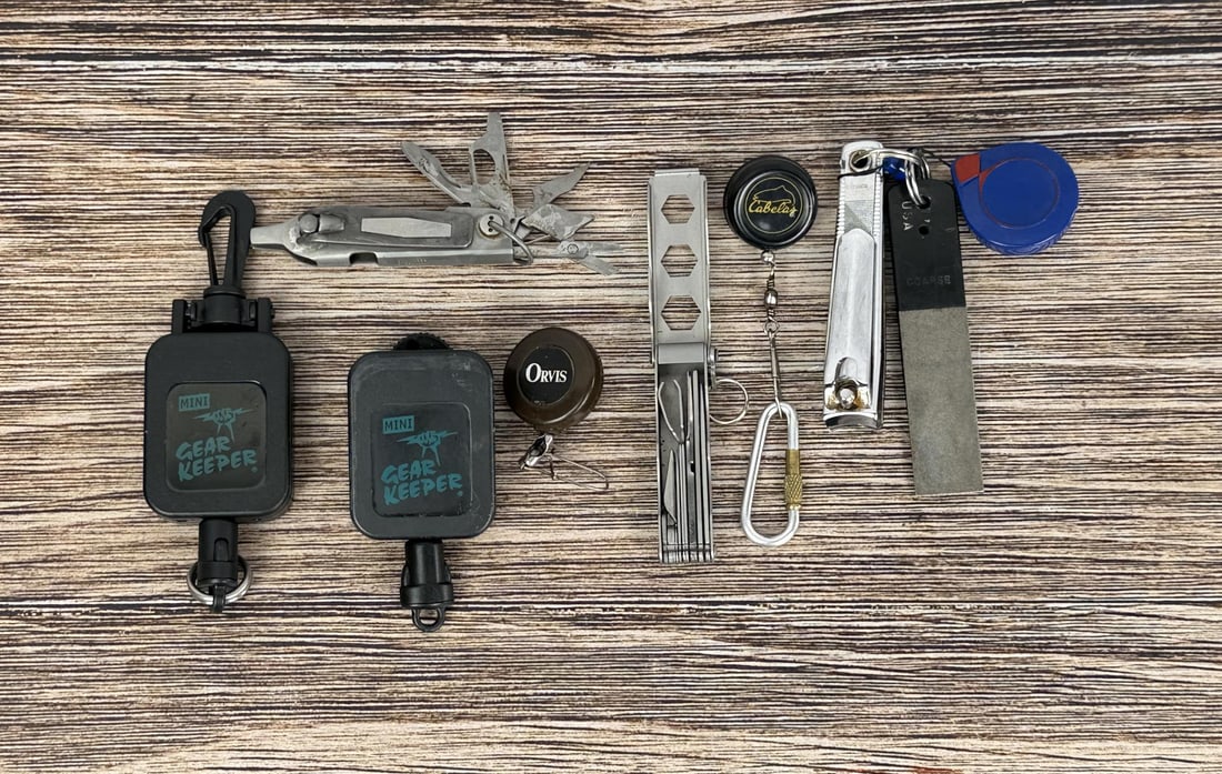 Fly Fishing Gear and Accessories: Includes gear keepers, Orvis nippers, a multi tool, fishing file, and a hook disgorger.