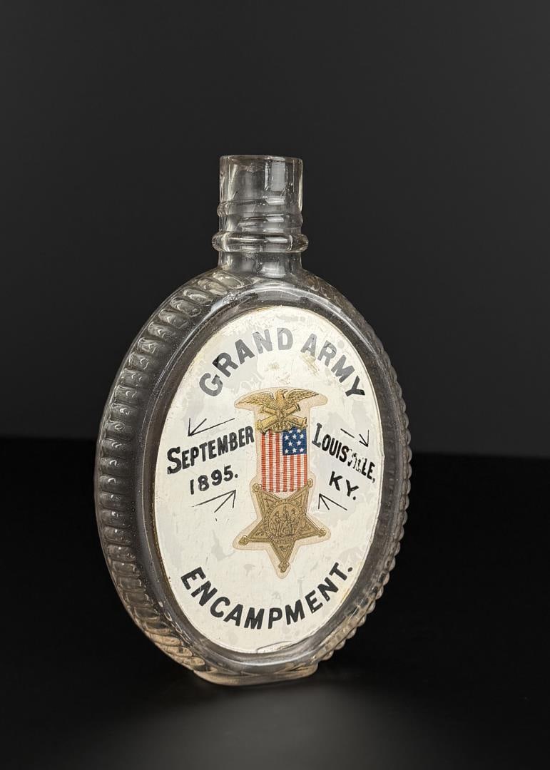 1895 GAR Encampment Label Under Glass Flask: 29th National Encampment. 1895, Louisville Kentucky. I.W. Harper's Whiskey. 6" tall.