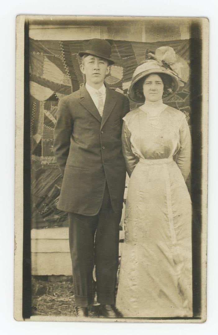 Young Couple Posing in Front of Crazy Quilt RPPC (1 of 3)