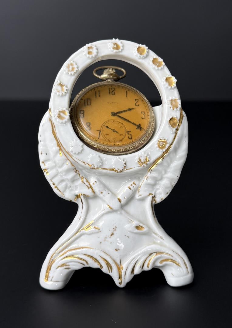 Elgin 14K Gold Filled Model 3 Pocket Watch: 4 1/2" by 3". Watch is not in working condition. Comes with porcelain mantle display.