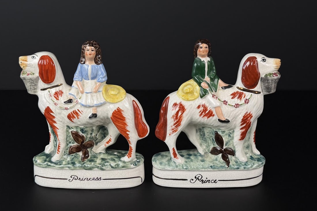Staffordshire Prince and Princess Dogs: 7 1/4" by 6 1/4" by 2 1/4". King Charles Cavalier spaniel Staffordshire dogs with flower baskets in their mouths and kids on their backs.