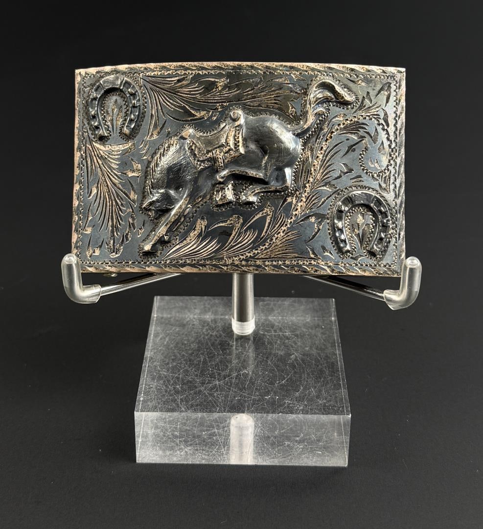 Sterling Silver Cowboy Bucking Bronco Belt Buckle: 3 1/4" by 2" by 1/4". 57.35 grams.
