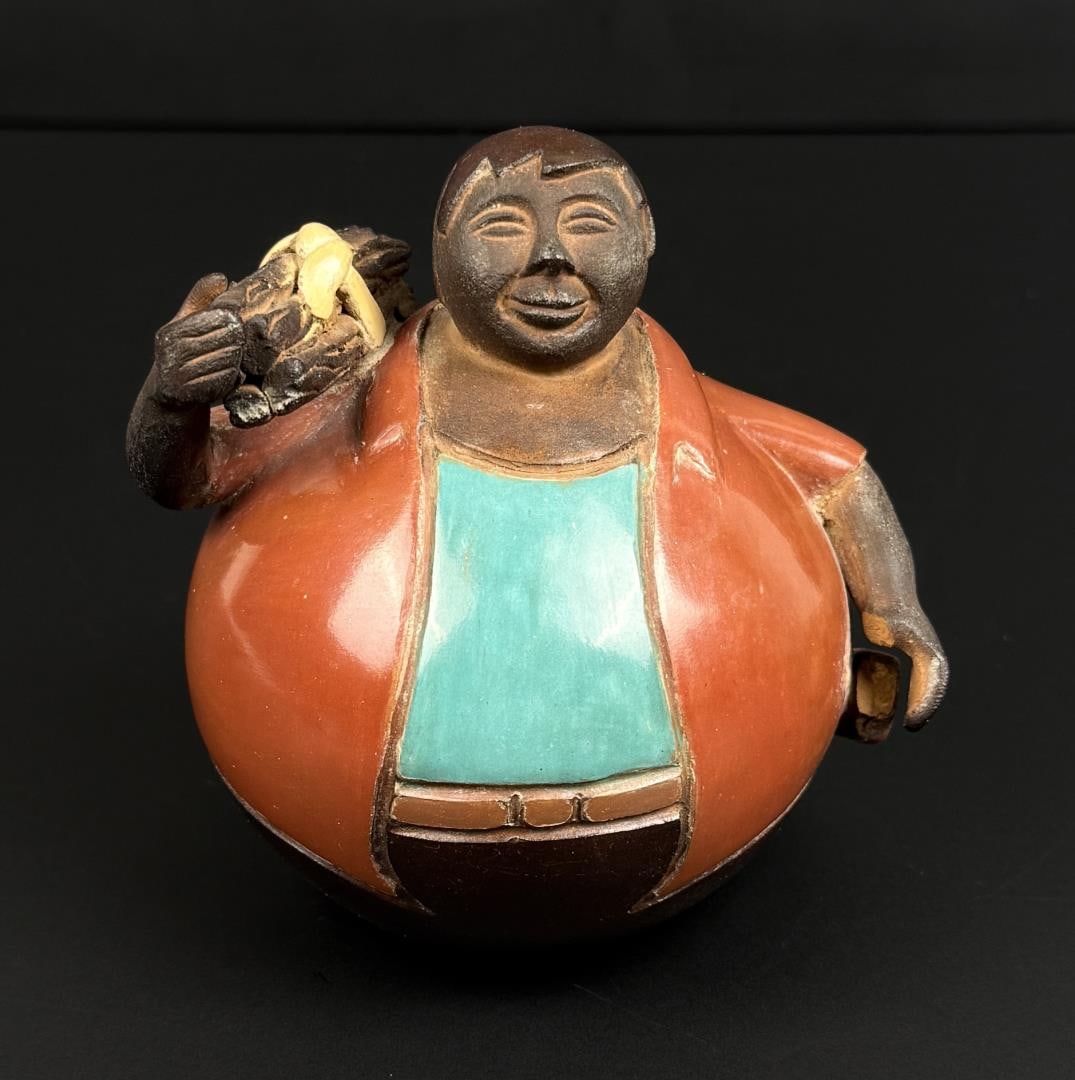 Signed Peruvian Chulucanas Clay Sculpture: Some damage to his left hand as shown. 4 1/8" by 3 3/4" by 3 5/8"