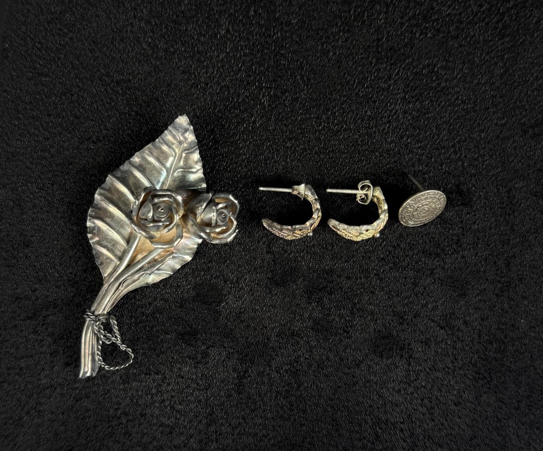 Group of Sterling Silver Jewelry: Group includes a brooch, a pair of earrings and an additional single earring. 10.03 grams total. The brooch is 2 3/8" long.