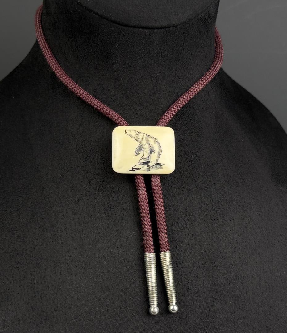 Alaskan Eskimo Polar Bear Scrimshaw Bolo Tie: 16 3/8" long. Native made prior to 1972. This item cannot be shipped to Oregon, California, Hawaii, New York, New Jersey, Internationally, or any other state that prohibits.